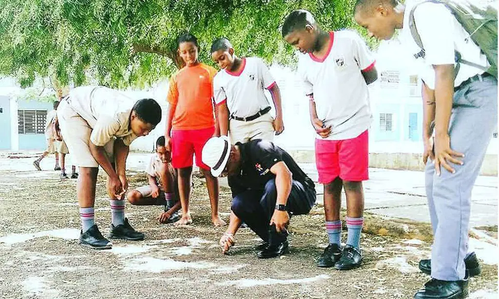Stephen Lashley playing marbles St. Leonard's Boys School